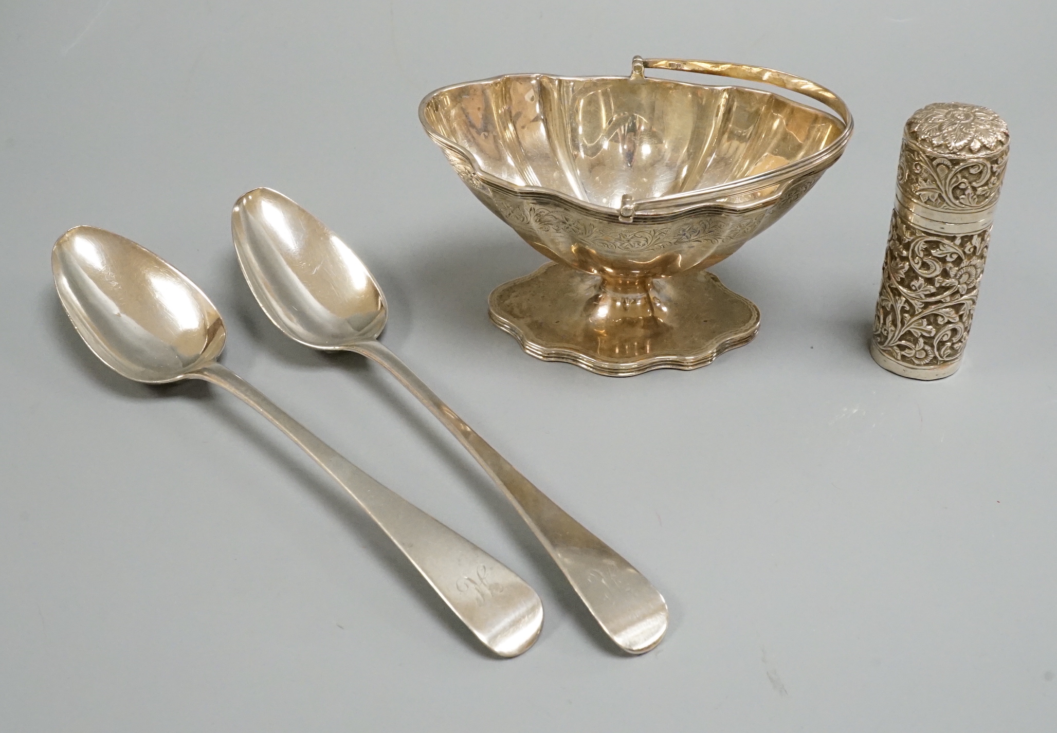A pair of George III silver Old English pattern tablespoons, London, 1810, a later silver sugar basket and Indian white metal canister.